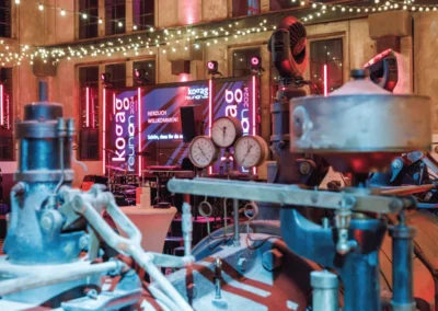 Ehemalige Mitarbeitende eines Unternehmens feiern ihr Wiedersehen bei einem Event in der Alten Maschinenhalle Solingen.